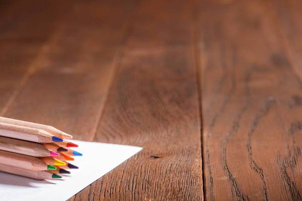 Blank paper and colorful pencils on the wooden table. - Fotografie, Obrázek