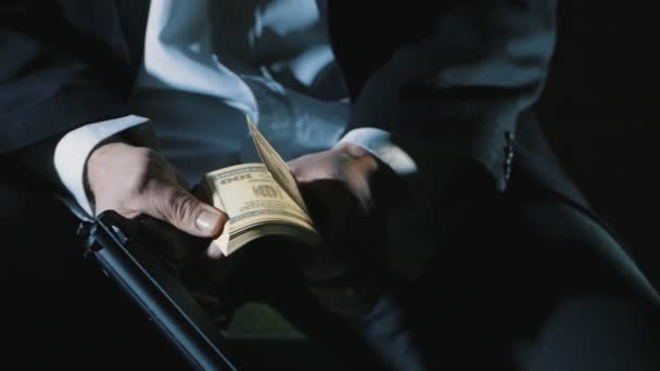 Detail rukou nebezpečného muže s pistolí počítá peníze. Špinavé peníze mafie. - Záběry, video