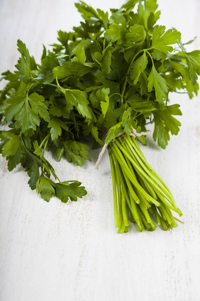 Fresh parsley on a light wooden background. - Photo, Image