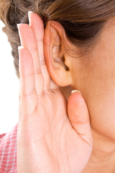 Girl listening with her hand on an ear - Fotó, kép