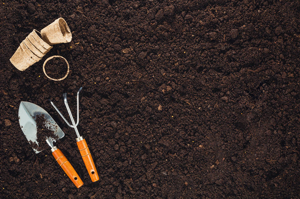 Gardening tools on garden soil texture background top view - 写真・画像