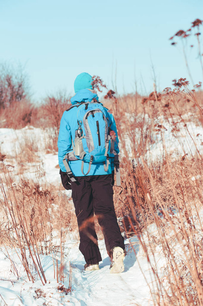 Boy hiking through meadows in the wintertime - Photo, Image
