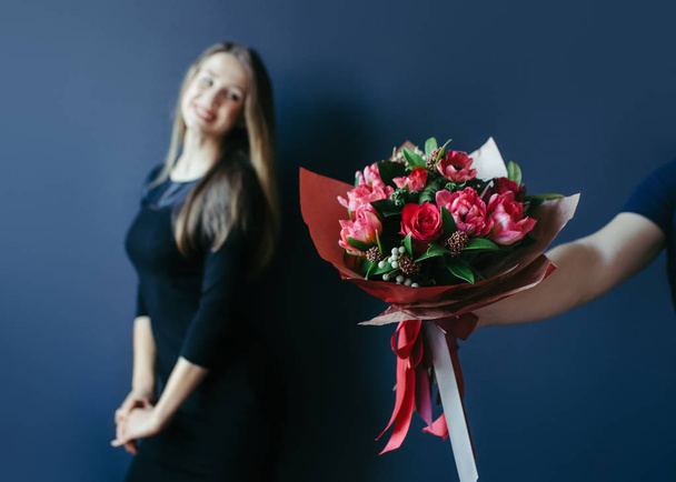 Bouquet of red tulips as boyfriends gift for cute girl. - Φωτογραφία, εικόνα