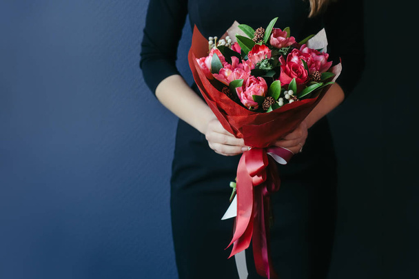 Bouquet of red tulips in girs hands. Unrecognisable. - Foto, Bild
