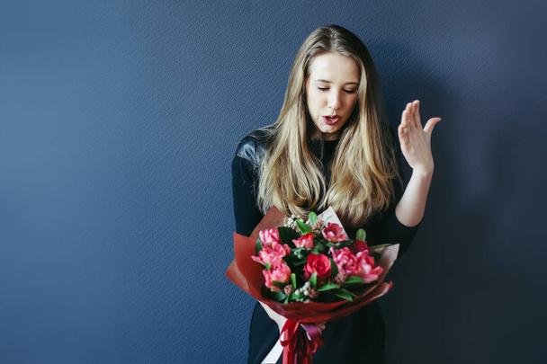 Cute girl with bouquet of red tulips. - Foto, immagini