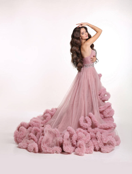 Beautiful Lady in luxury lush pink dress. Fashion brunette woman - Photo, image