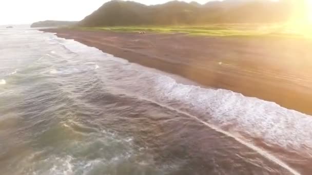 Flying over the ocean. Sea waves. Sunset Pacific Ocean. People in the wild - Footage, Video