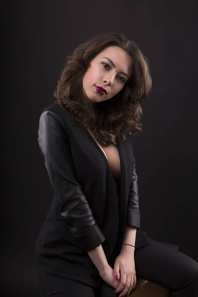Stunning young woman with decollete  and leather jacket - Fotoğraf, Görsel