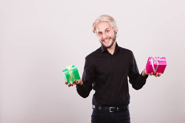 man holding two gift boxes in hands - Foto, afbeelding