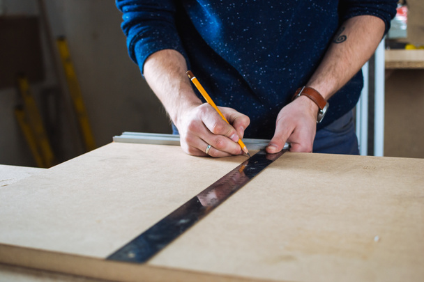 Young man working as carpenter  - Фото, зображення