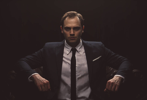 Portrait of a businessman on black background - Valokuva, kuva