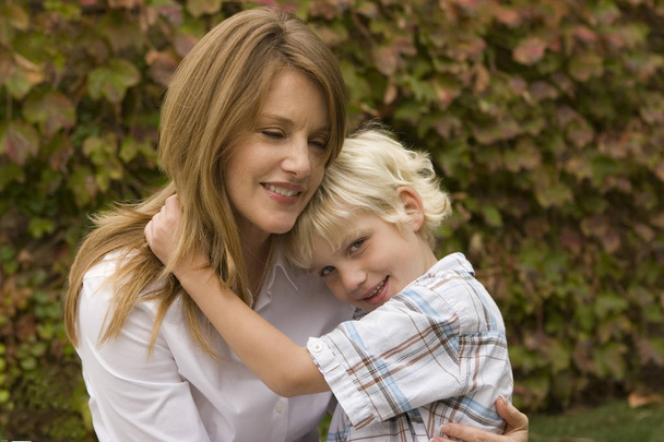 Happy mother hugging her son outside. - Foto, Imagen
