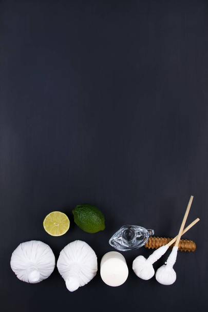 Spa set for Thai massage on a black table - Foto, imagen