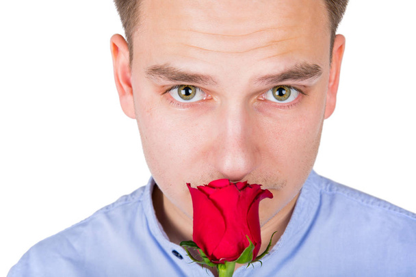 Handsome guy smelling red rose - Foto, afbeelding