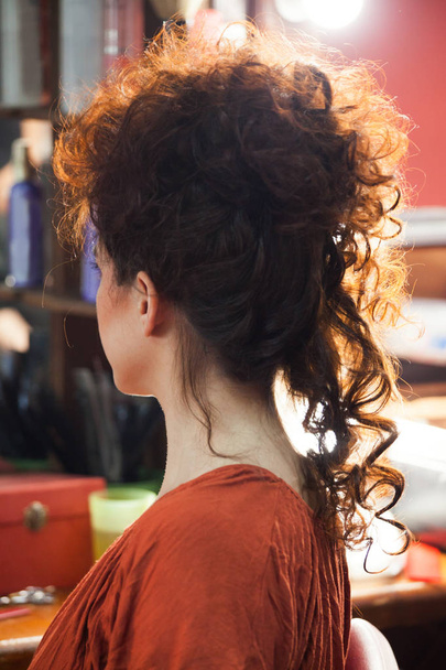 woman with raised long curly hair at hairdresser - Φωτογραφία, εικόνα