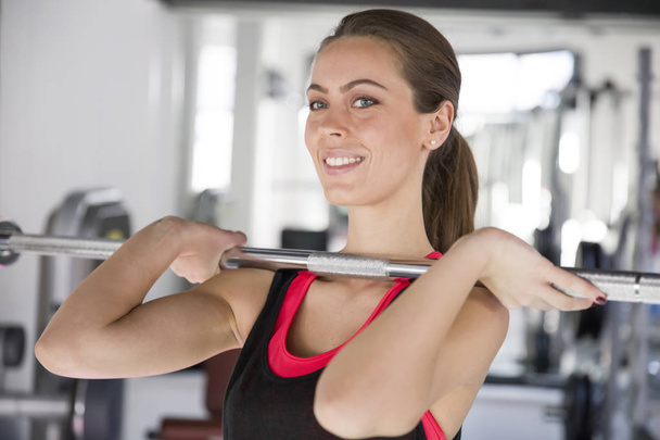Young woman exercising in the gym - Photo, Image