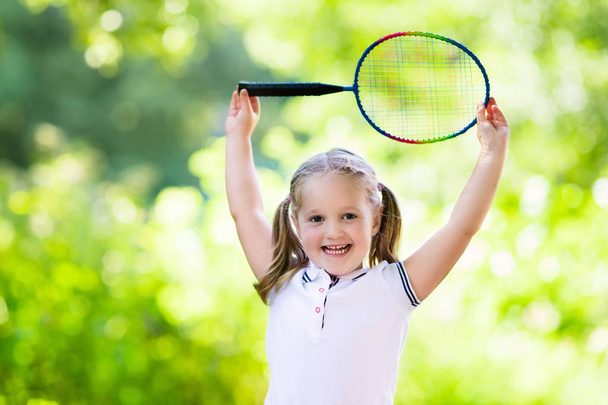 Child playing badminton or tennis outdoor in summer - Photo, Image