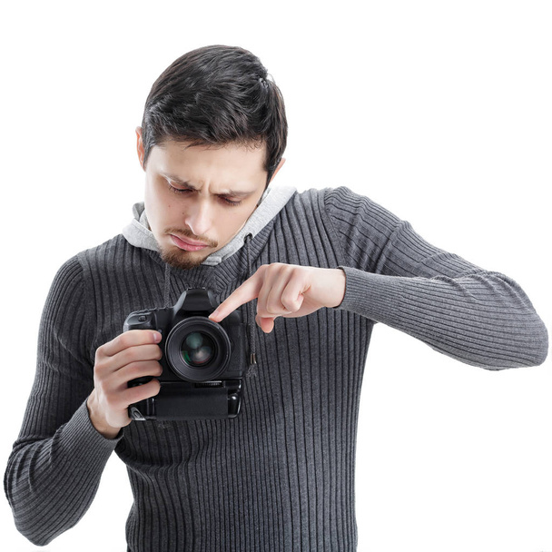 young photographer sets up the camera isolated on white backgrou - Zdjęcie, obraz