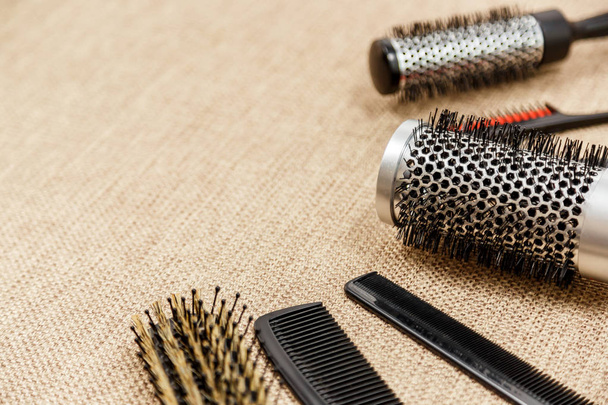 Combs and hairdresser tools on beige background - Fotó, kép