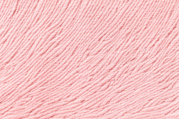 Licht roze achtergrond van zacht textiel materiaal. Stof met natuurlijke textuur. - Foto, afbeelding