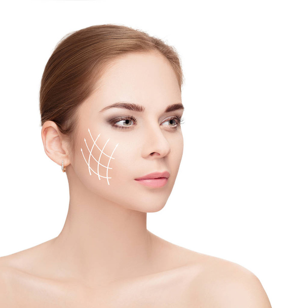 Spa portrait of woman with arrows on her face on white backgroun - Photo, Image