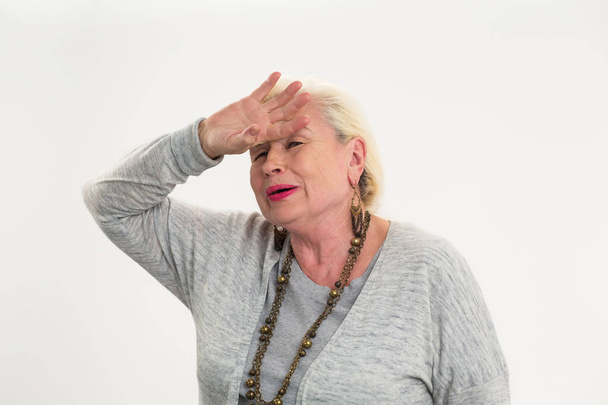 Senior woman touching her forehead. - Valokuva, kuva