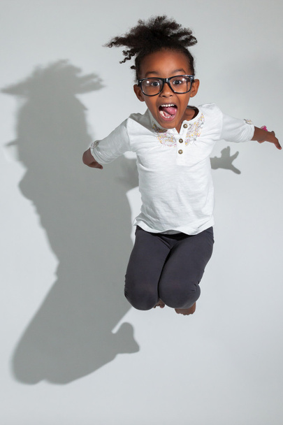 Portrait of Young African American girl jumping - Фото, зображення