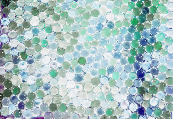 Мраморный кристально чистый шар, радужный разноцветный блестящий фон. Выборочный фокус. Многоцветные
 - Фото, изображение