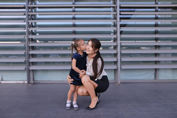 Beautiful modern girl, young mother, business woman squatted dow - Photo, Image
