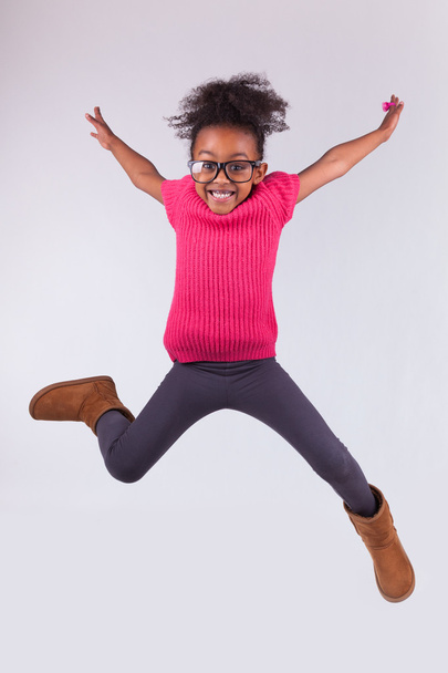 Portrait of Young African American girl jumping - Fotografie, Obrázek