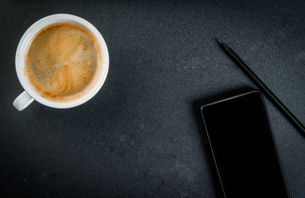 Smartphone and a coffee mug  - Photo, image