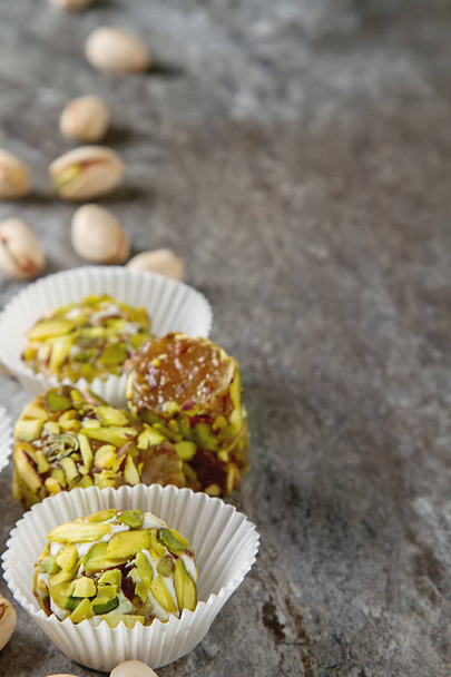Eastern sweets. Turkish delight with pistachios in a vase. Dark  - Fotó, kép