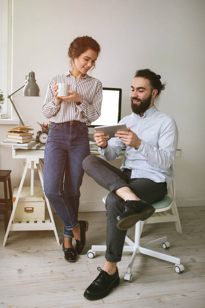 Young adults hipster male and female working at home - Fotó, kép