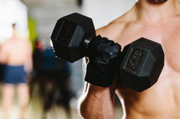 athletic male with dumbbells workout - Photo, image