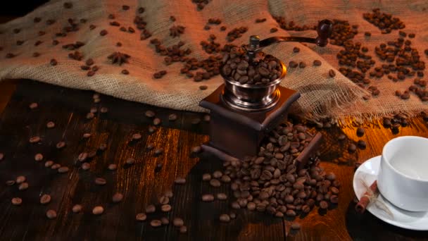 Wooden table with coffee mill full of with coffee beans - Séquence, vidéo
