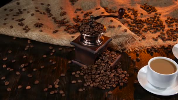 Two cups with latte on table strewn with coffee beans - Imágenes, Vídeo