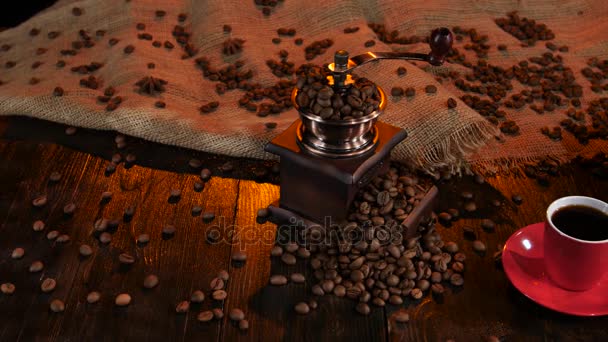 Coffee grinder full of coffee beans and cup of espresso - Πλάνα, βίντεο