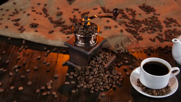 Teapot and cup coffee on saucer with grains of coffee - Materiał filmowy, wideo