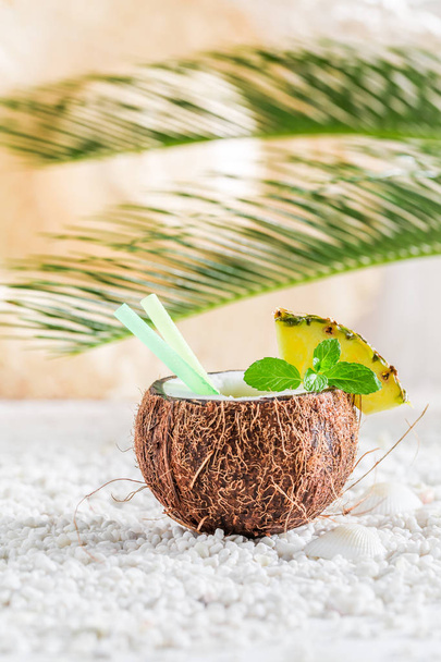 Tasty pinacolada in coconut in sunny day - Foto, afbeelding