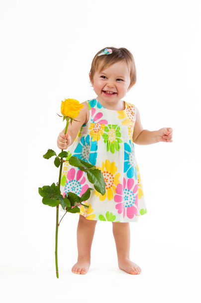 Little cute girl with beautiful yellow rose, romantic gift - Foto, imagen