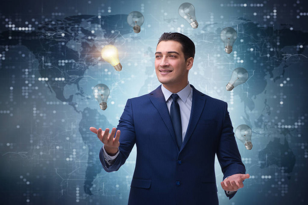 Businessman juggling lightbulbs in new idea concept - Photo, Image
