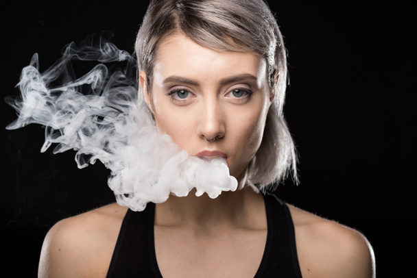 Young woman vaping - 写真・画像