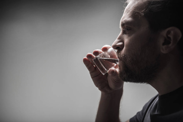 Close up of addicted man drinking alcohol - Foto, imagen