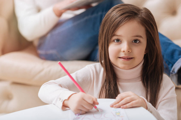 Positive cute girl drawing a picture - Photo, image