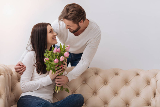 Handsome caring man giving a flower bouquet - Foto, afbeelding