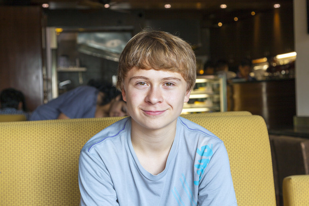 Smart boy sitting in a fastfood restaurant - Photo, Image