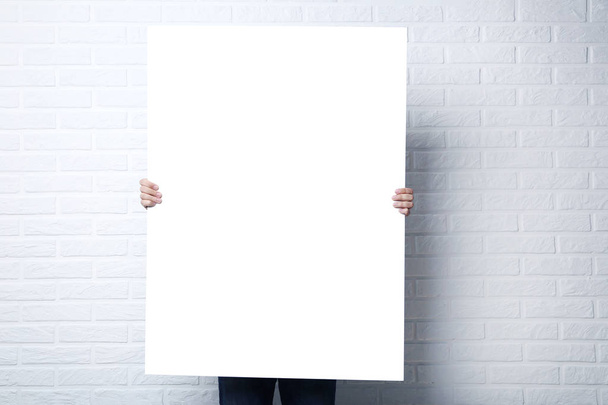 Man holding blank poster  - Foto, Imagen