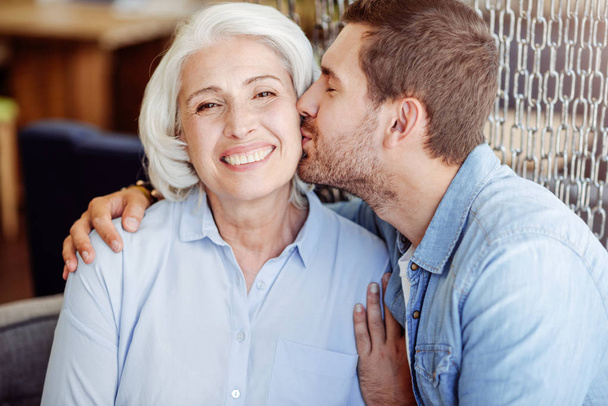 Positive man kissing his grandmother - Foto, Imagen
