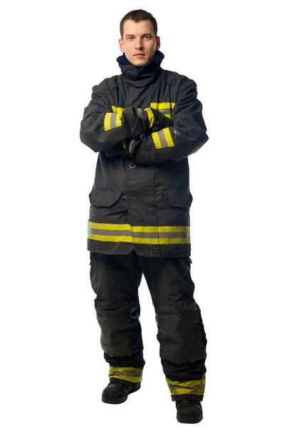 портрет молодого пожарного в грязной рабочей одежде
 - Фото, изображение