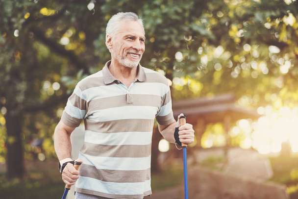 Positive aged man enjoying physical exercise - Foto, imagen